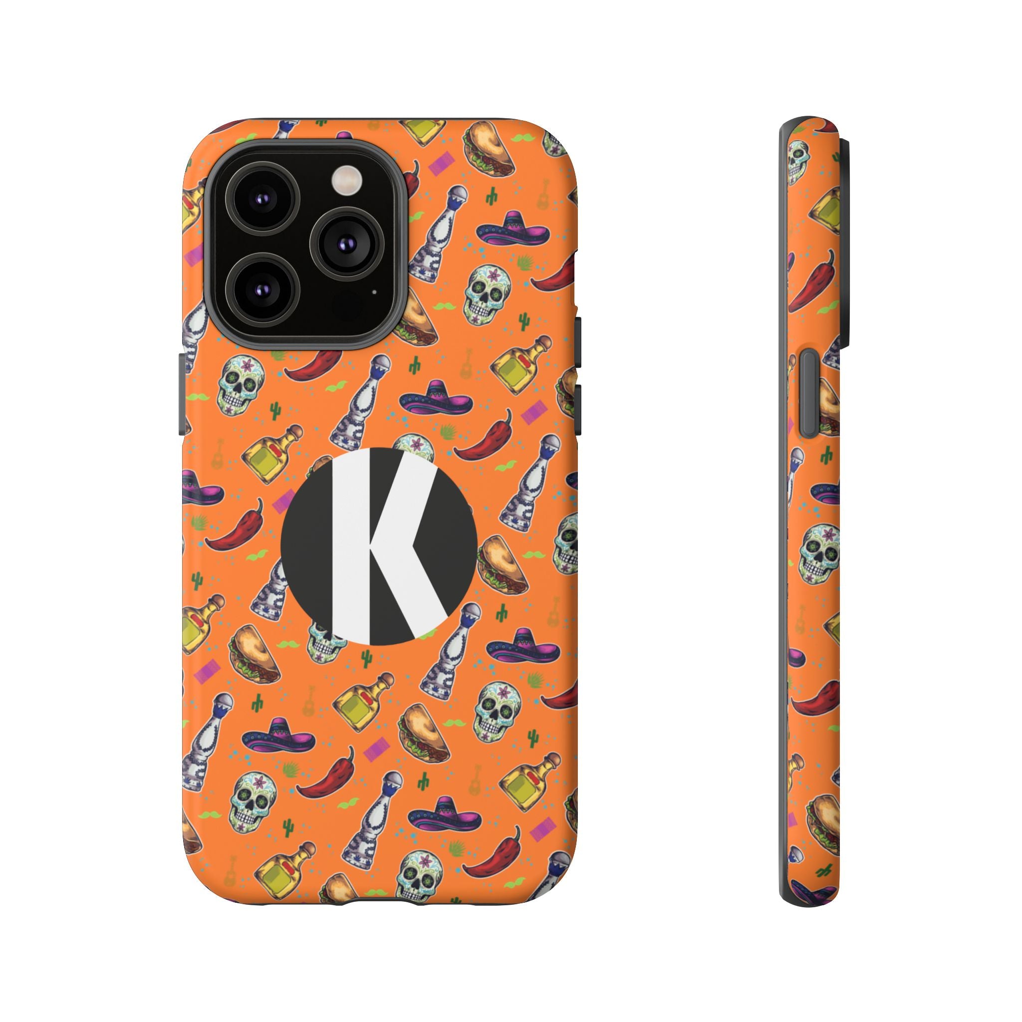 An orange phone case with a festive Mexican-themed pattern of skulls, sombreros, tequila bottles, and chili peppers, featuring a large black circle with a white letter 'K' on the back. Shown in a back view and a side profile view against a plain white background.