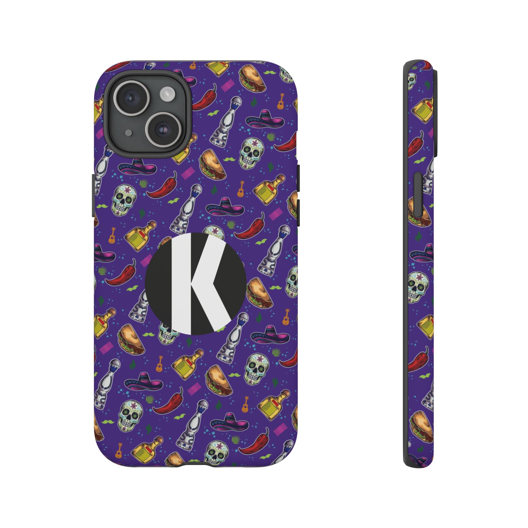 A purple phone case with a colorful Halloween-themed pattern of skulls, hot peppers, witch hats, and bottles, featuring a large black circle with a white letter 'K' on the back. Shown from the back and side views on a white background.