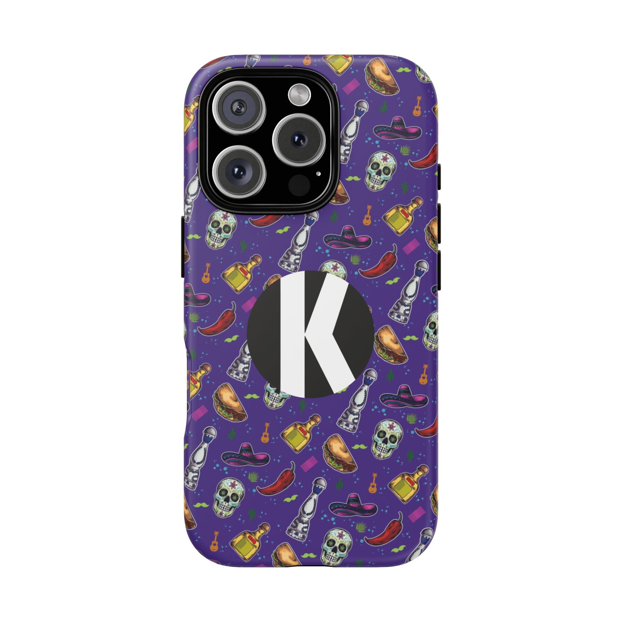 A purple phone case with a Halloween-themed pattern of skulls, hats, bottles, and chili peppers, featuring a large black circle with a white letter 'K' on the back.
