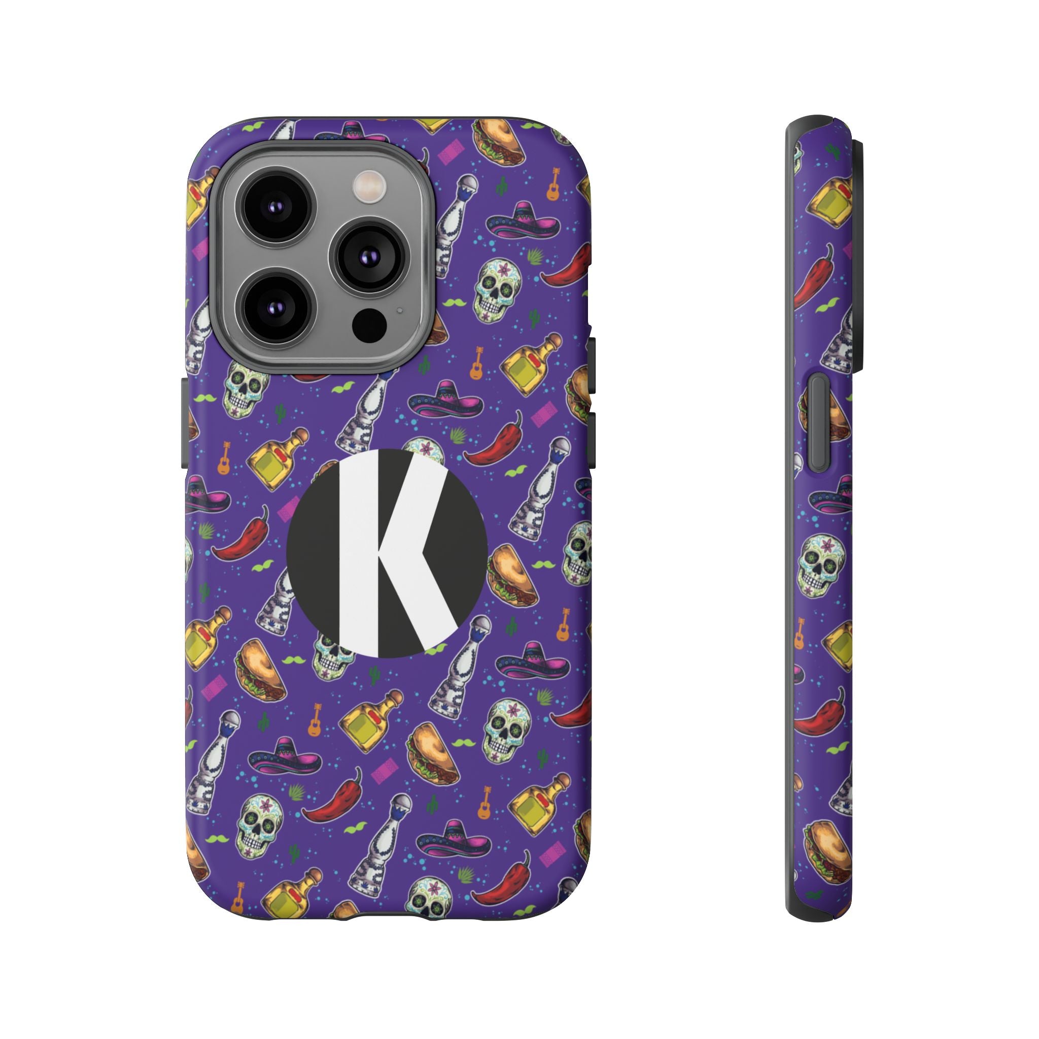 A purple phone case with a colorful Halloween-themed pattern of skulls, hats, bottles, and chili peppers, featuring a large black circle with a white letter 'K' on the back. Shown from the back and side views on a plain white background.