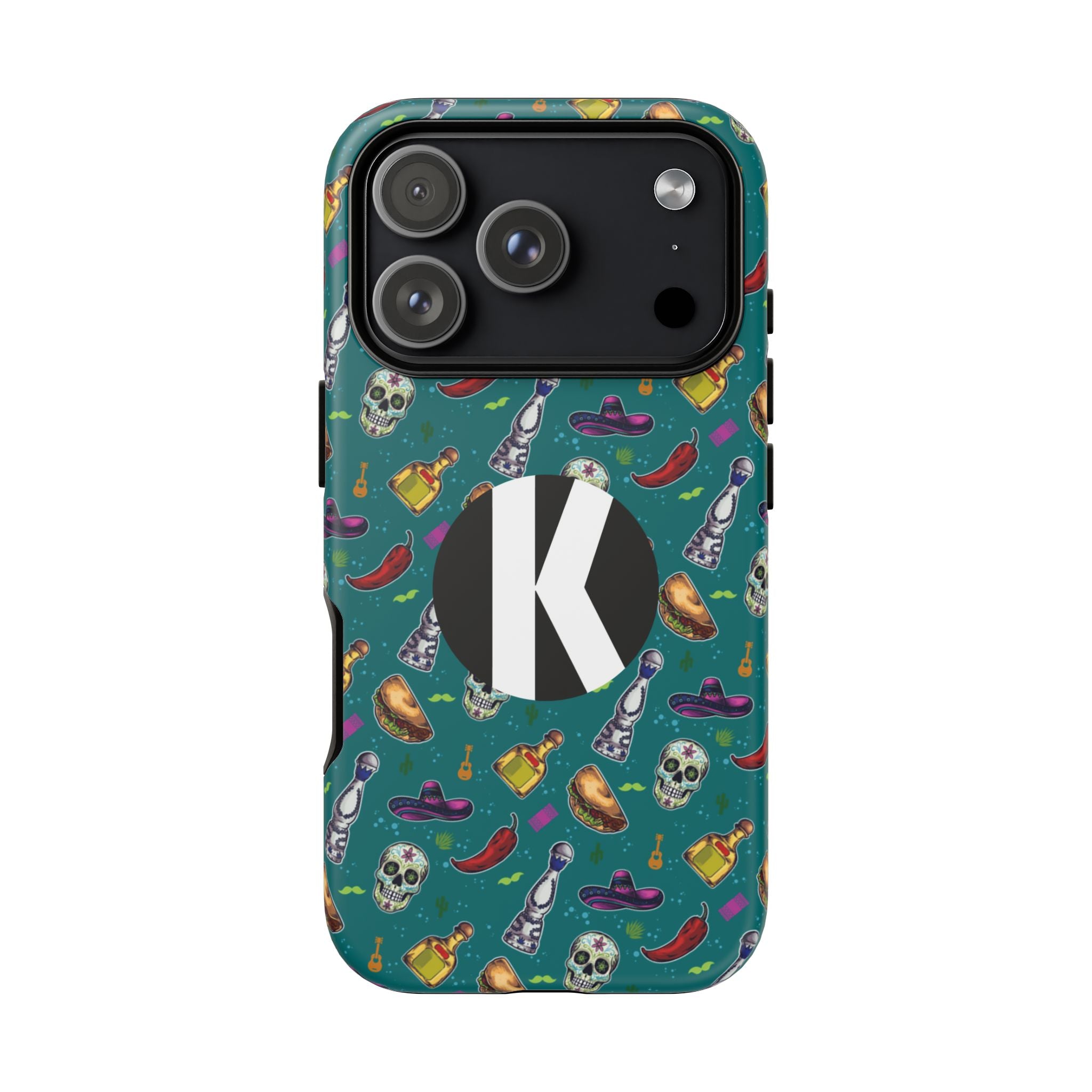 A protective phone case with a teal background and a colorful Mexican-themed pattern featuring skulls, chili peppers, sombreros, and tequila bottles. It has a large black circle on the back with a white letter 'K' in the center.