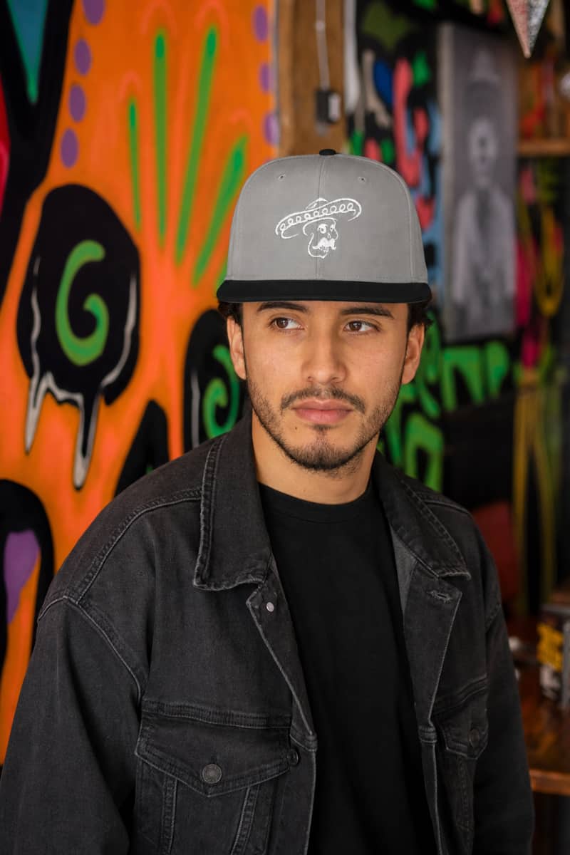 Man wearing the Kalaveras Signature Skull Snapback at the Bellflower restaurant
