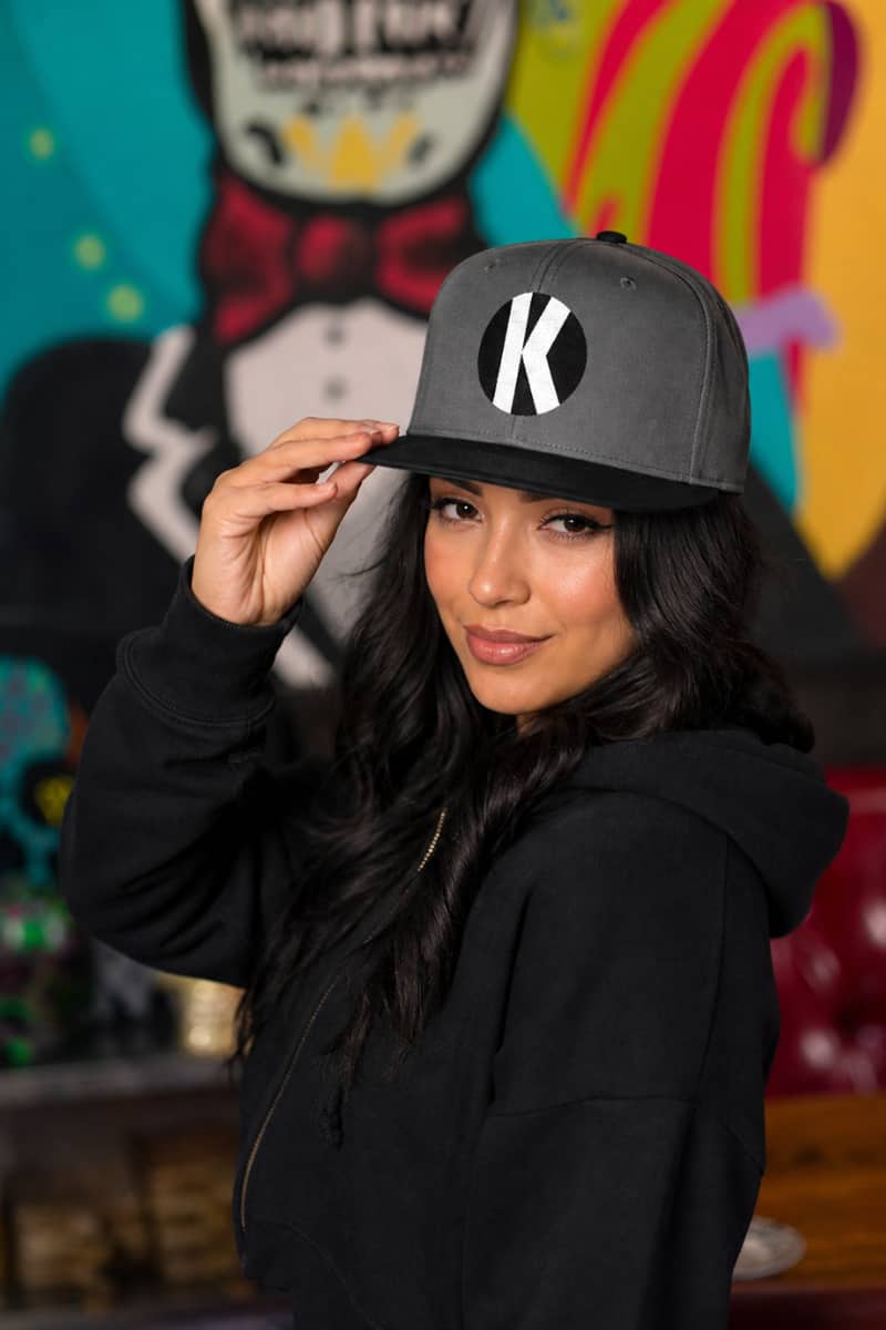 Woman wearing the Kalaveras Monogram Snapback inside the Fullerton restaurant